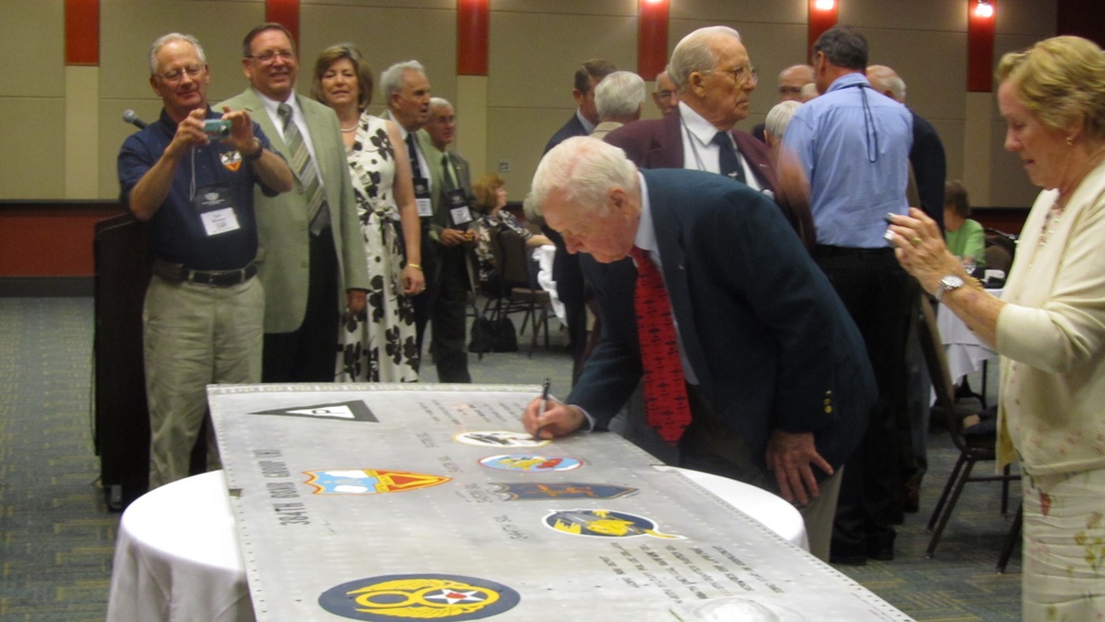 Gene Goodrick signing the wing panel.