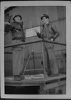 Two unidentified men, one in German helmet