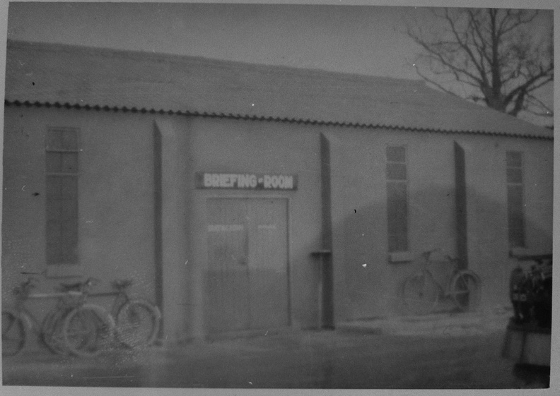 384th BG Briefing Room, Grafton Underwood
Location of this building is uncertain. Note the shadow of a Nissen Hut on the side of the building.
Photo from the Ken Decker Collection, courtesy of Mark Meehl, 2019. 302529.JPG